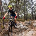 Fox Superflow race MTB launching over rock garden.