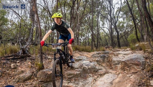 Fox Superflow race MTB launching over rock garden.